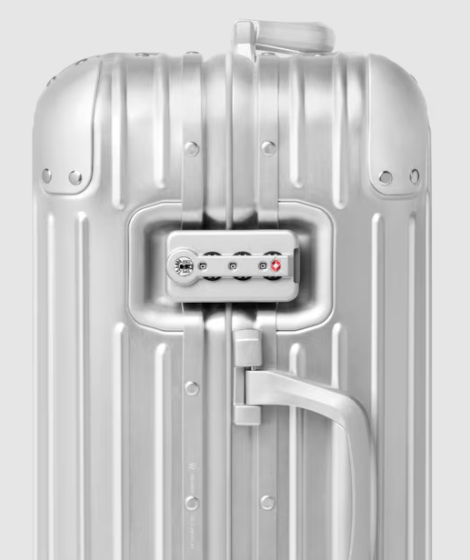 Close-up of the TSA-approved combination lock on an aluminium suitcase